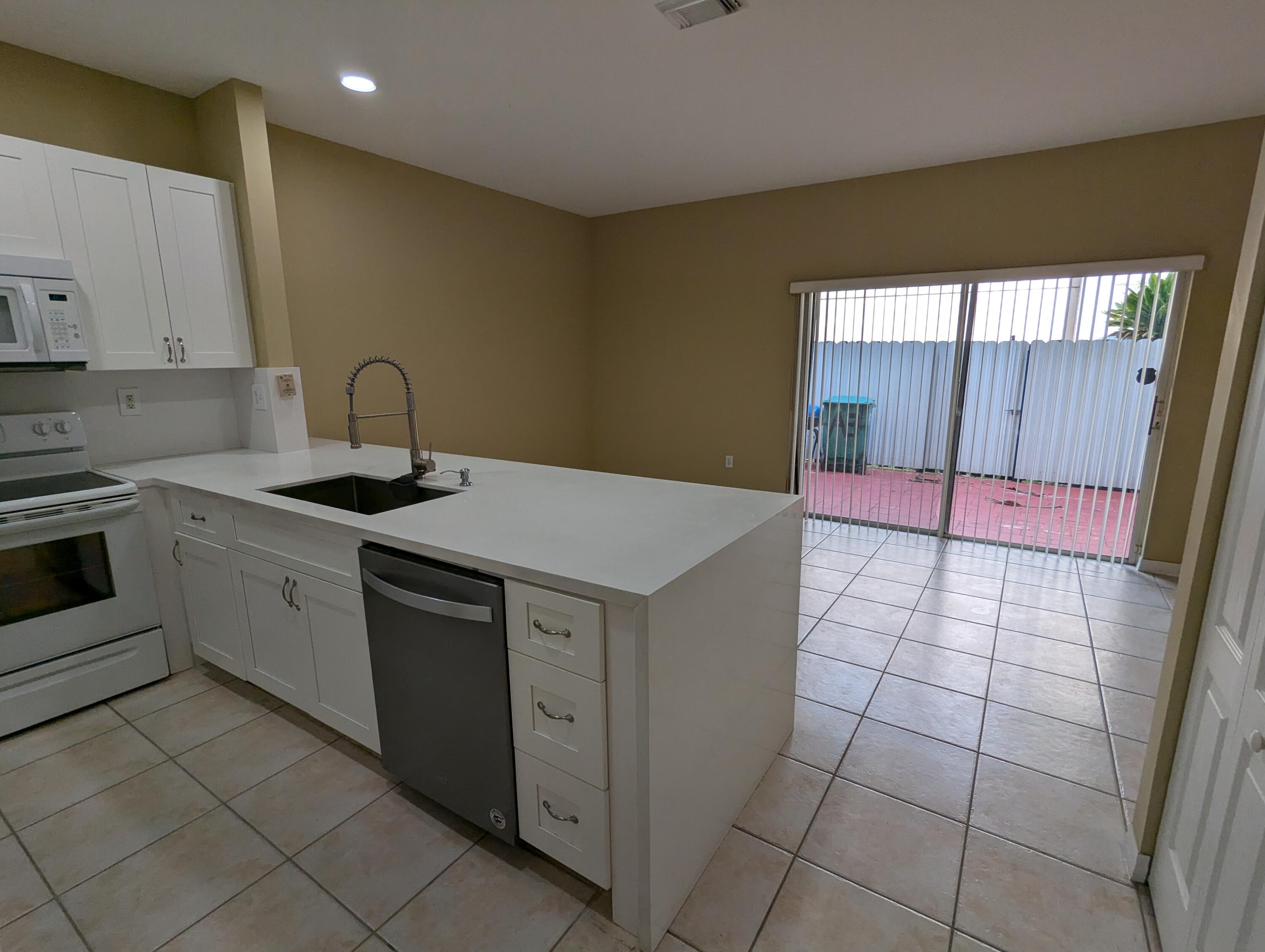 Undisclosed Address Miami, FL 33126 - Photo 3 of 14 a kitchen that has a sink and a stove