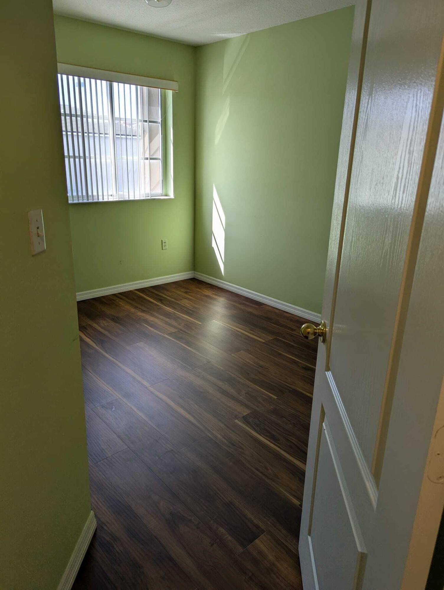 Undisclosed Address Miami, FL 33126 - Photo 10 of 14 a view of empty room with window and hardwood floor