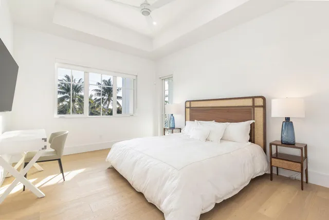 a spacious bathroom with a tub sink and mirror