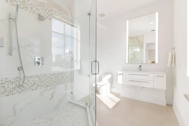 a bathroom with a toilet sink and mirror