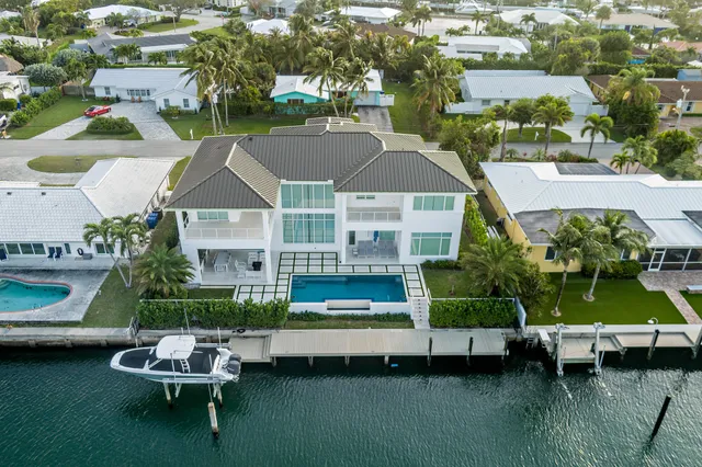 a aerial view of a house with a yard table and chairs