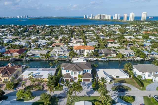 an aerial view of a house with a lake