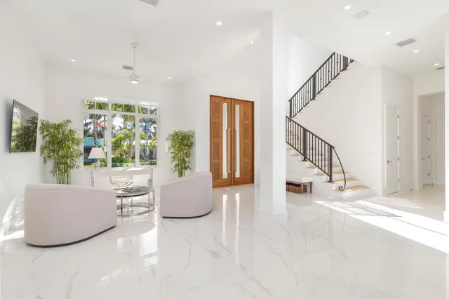 a living room with fireplace furniture and a potted plant