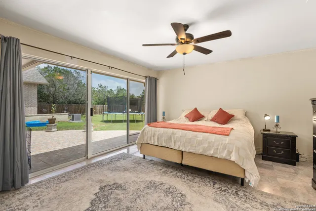 a bedroom with a bed and a large window