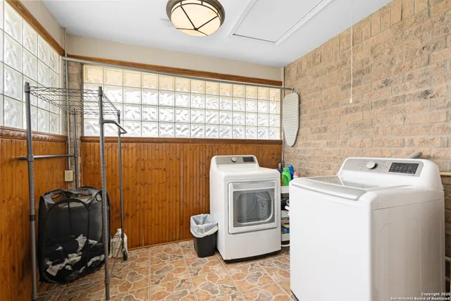 a view of washer and dryer near a bathroom