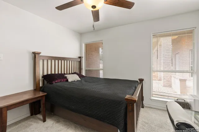 a bed sitting in a bedroom next to a window