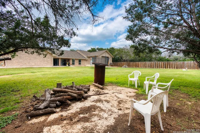 a view of a chairs and table in the garden