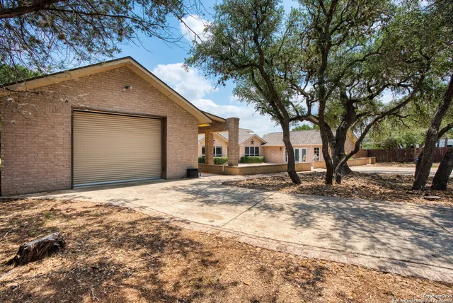 a backyard of a house with large trees