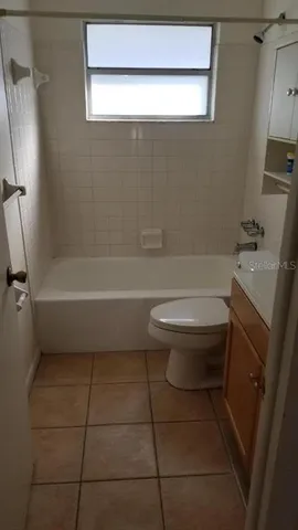 a bathroom with a toilet a sink and bathtub