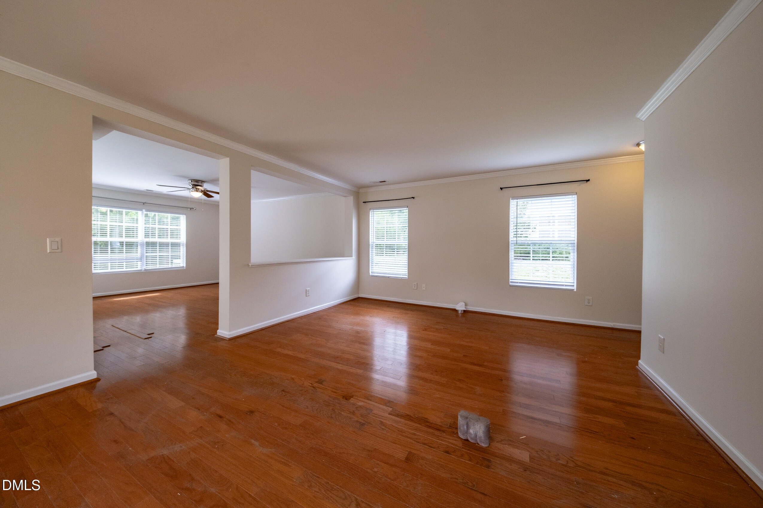 719 Obsidian Way Durham, NC 27703 - Photo 9 of 41 an empty room with wooden floor and windows