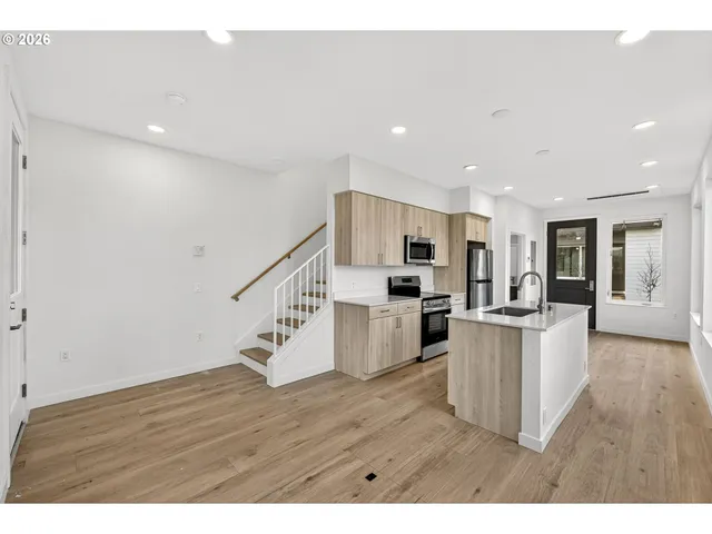 a view of kitchen with wooden floor and electronic appliances