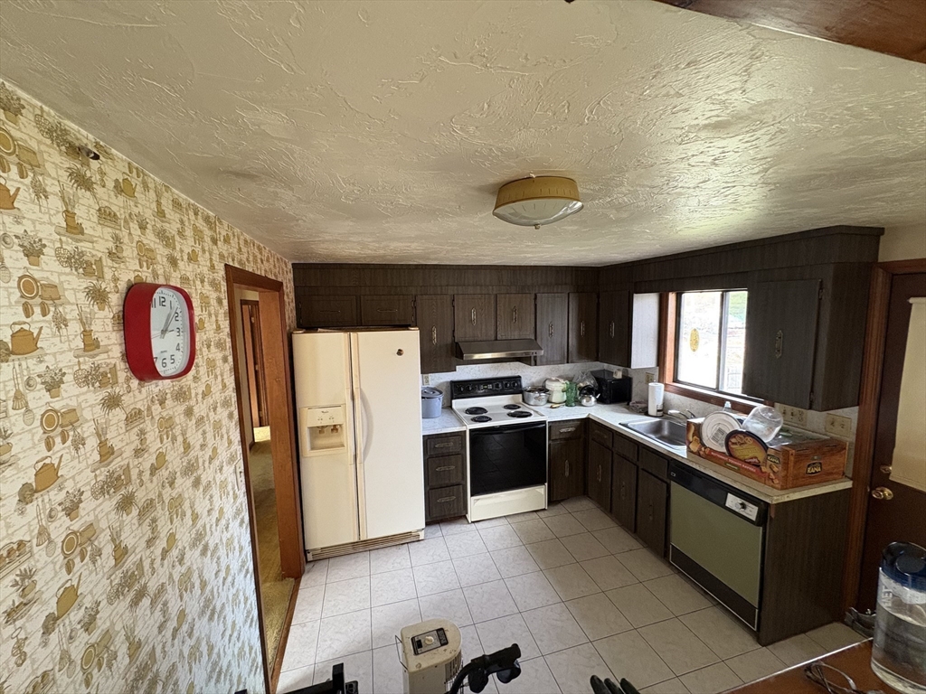 172 Russ Street Randolph, MA 02368 - Photo 8 of 15 a kitchen with stainless steel appliances granite countertop a refrigerator and a stove top oven