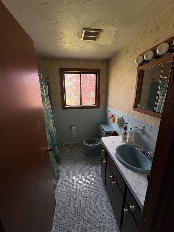 172 Russ Street Randolph, MA 02368 - Photo 9 of 15 a bathroom with a sink a toilet and mirror