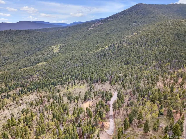 a view of mountain with sunset in background