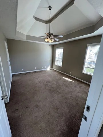 an empty room with windows and entrance