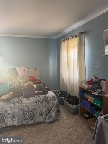 a living room with furniture a flat screen tv and a window
