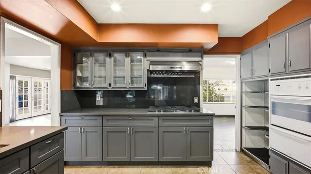 a kitchen with stainless steel appliances granite countertop a stove and a microwave