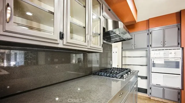 a kitchen with stainless steel appliances granite countertop a stove and a refrigerator
