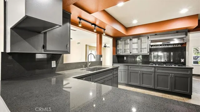 a kitchen with stainless steel appliances granite countertop a sink a stove and a microwave