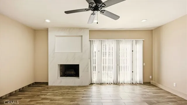 a view of a livingroom with a chandelier fan and fire place