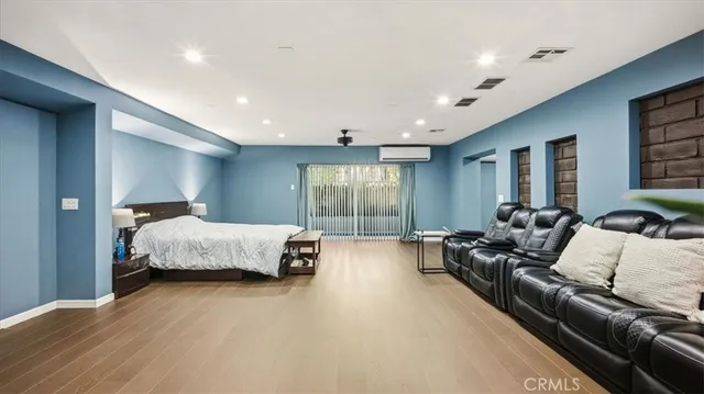a view of empty room with wooden floor and ceiling fan
