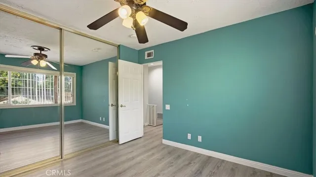 a view of a livingroom with a ceiling fan and window