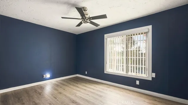 a view of a livingroom with a ceiling fan and window