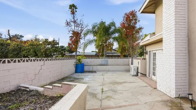 a view of a house with a wooden fence