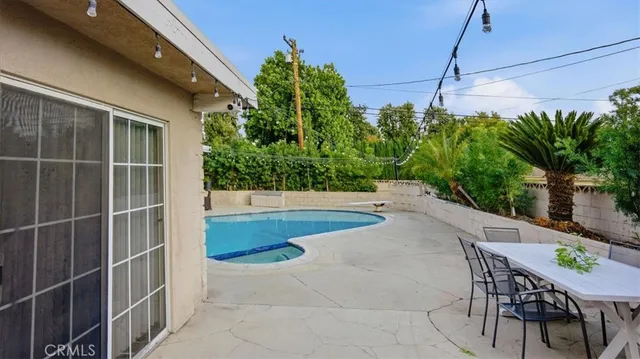a view of a white house with a swimming pool