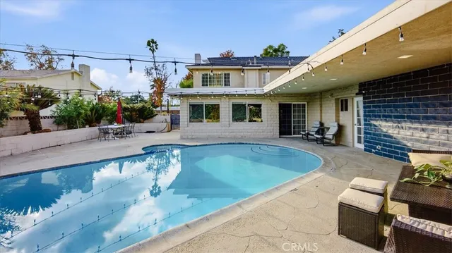 a view of a swimming pool with a patio