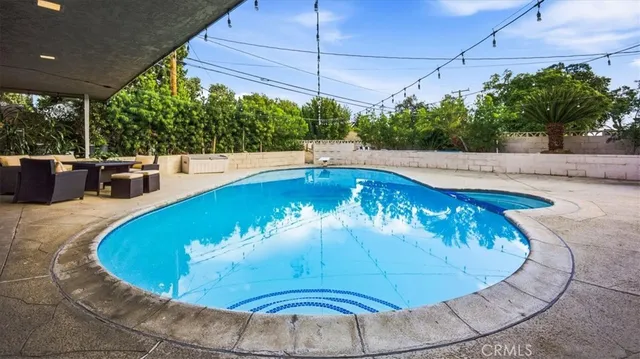 a view of a swimming pool with a chairs