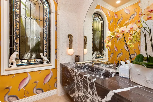 a living room with furniture fireplace and a large window