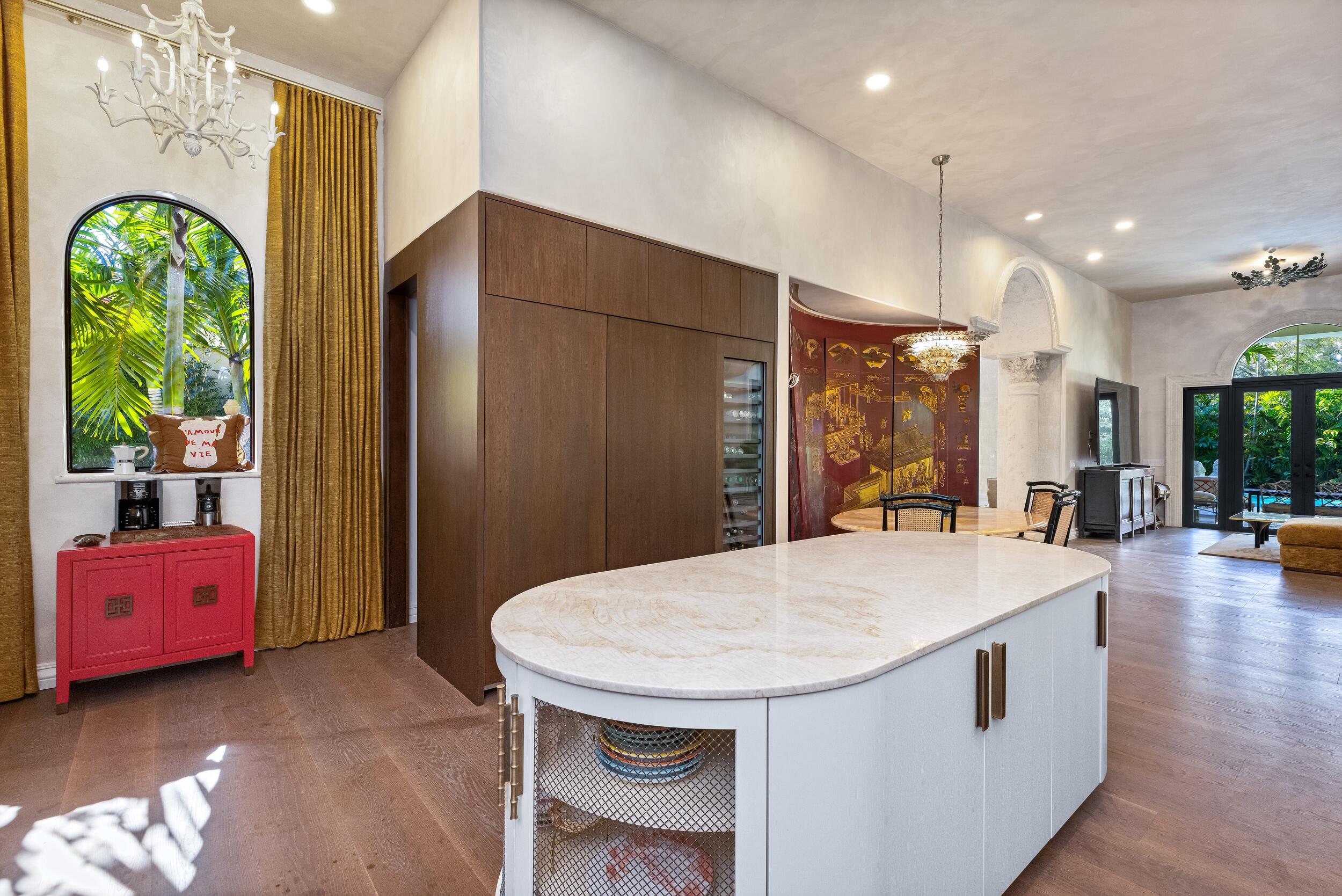 422 Addison Park Lane Boca Raton, FL 33432 - Photo 19 of 70 a kitchen with stainless steel appliances a dining table chairs and couches with large windows