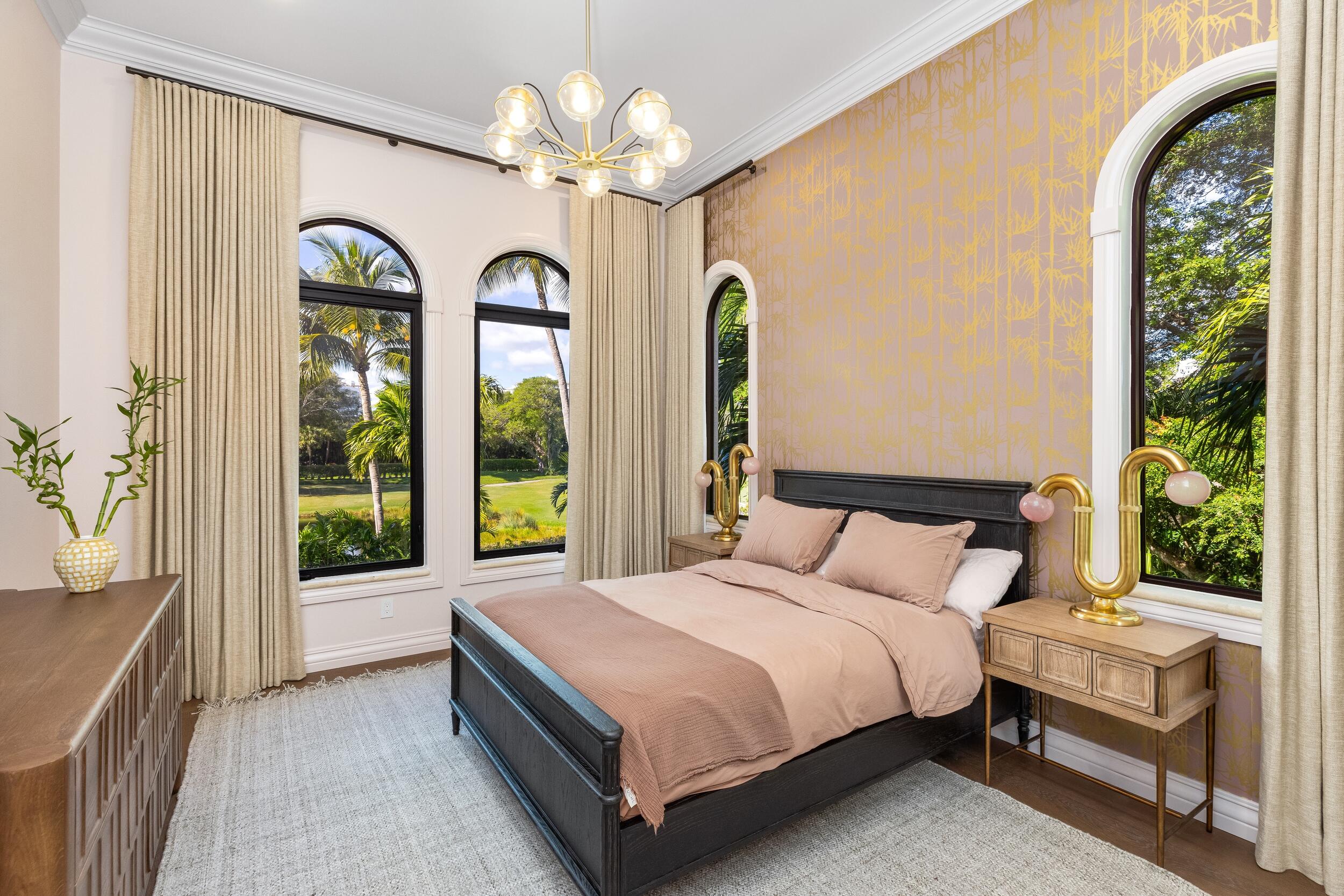 422 Addison Park Lane Boca Raton, FL 33432 - Photo 46 of 70 a bedroom with a large bed and a chandelier