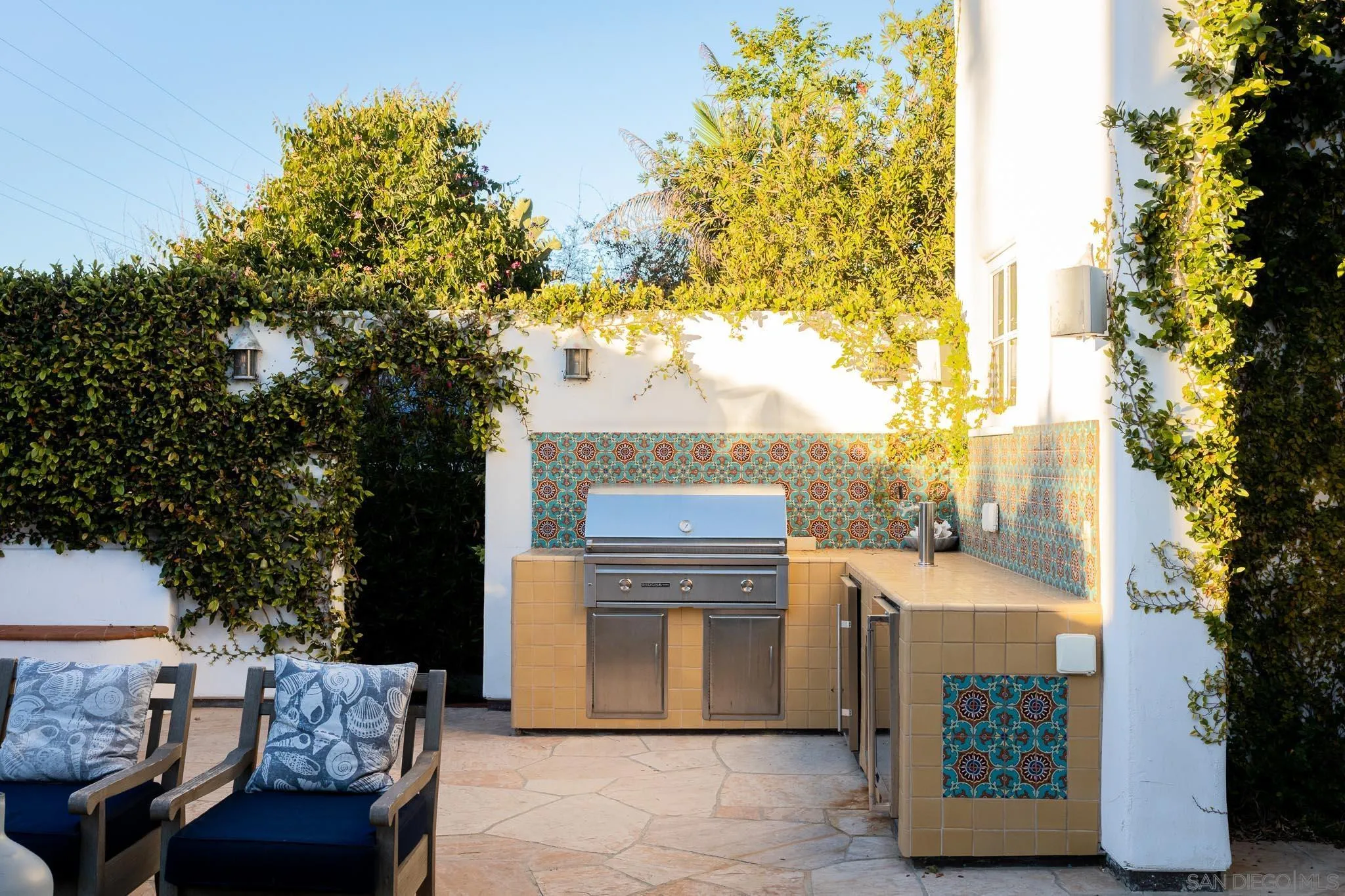 1004 Devonshire Drive San Diego, CA 92107 - Photo 40 of 54 a view of a patio with couches and table and chairs with wooden fence and floor