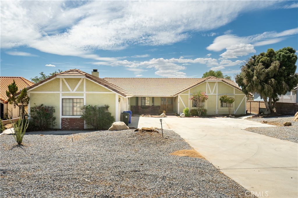 13744 Choco Road Apple Valley, CA 92307 - Photo 1 of 1 a front view of a house with a yard and garage