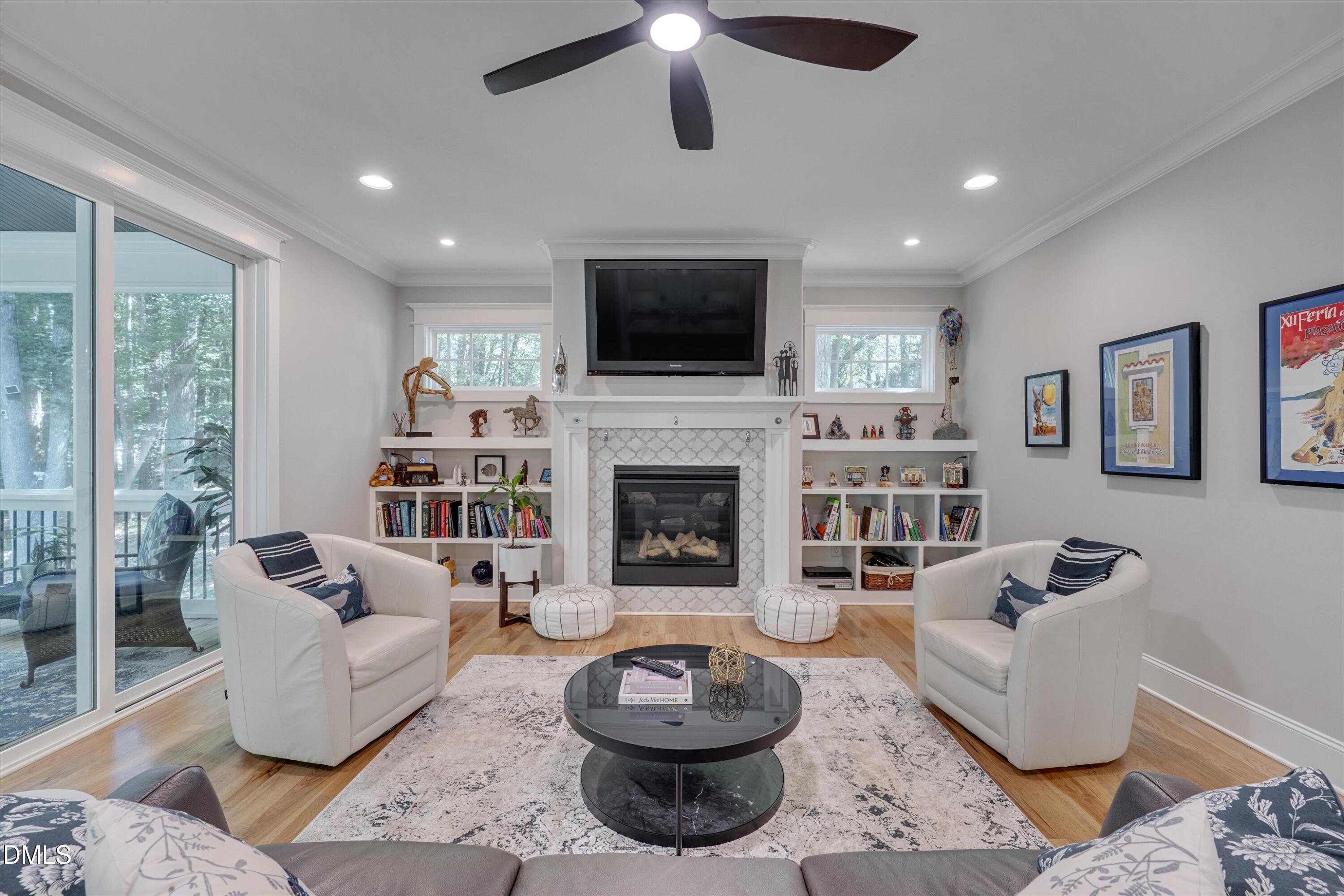 8601 Oneal Road Raleigh, NC 27613 - Photo 16 of 87 a living room with furniture a flat screen tv and a fireplace