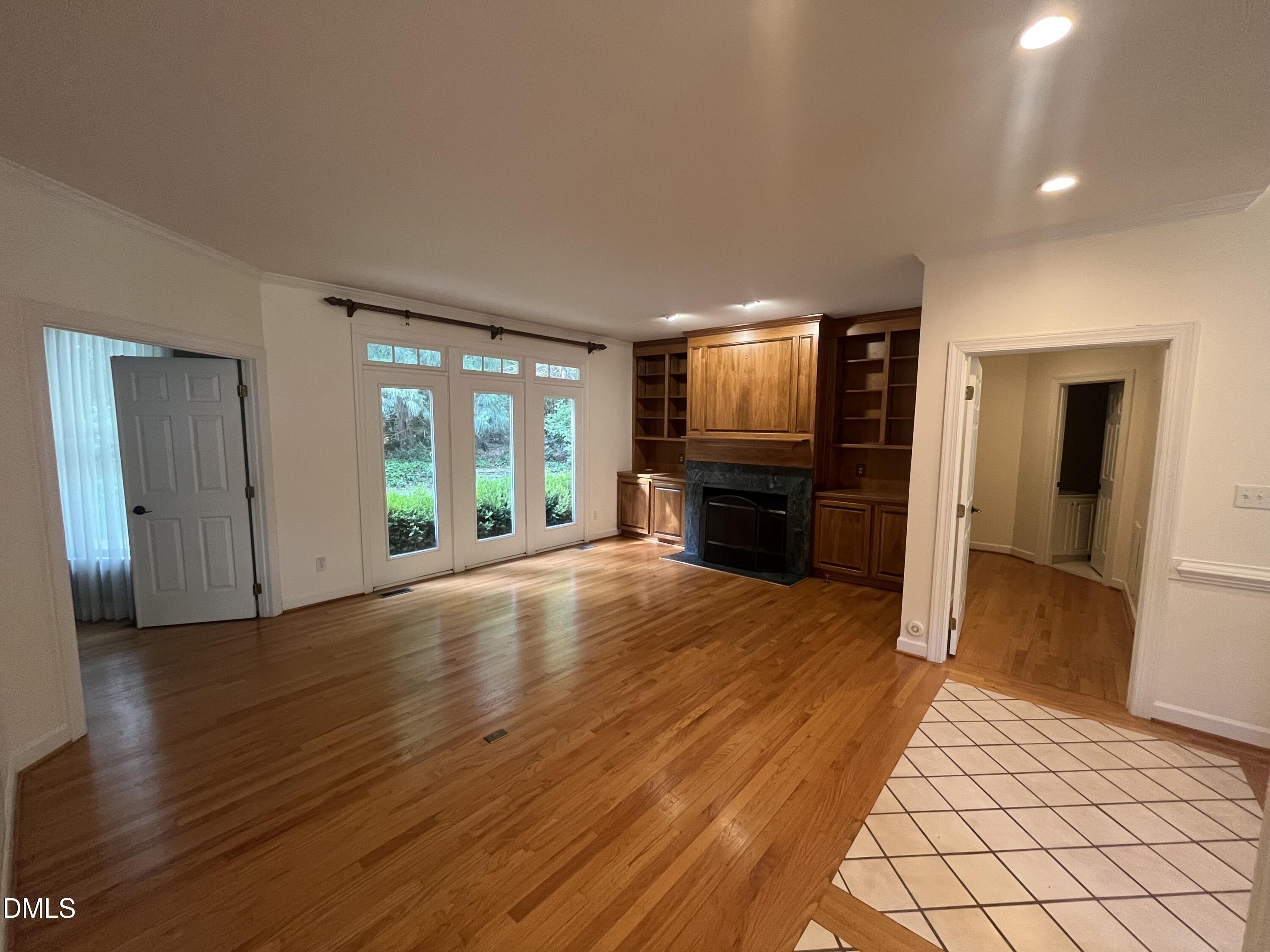 205 Berry Hill Drive Raleigh, NC 27615 - Photo 3 of 53 a view of an empty room with wooden floor and a window