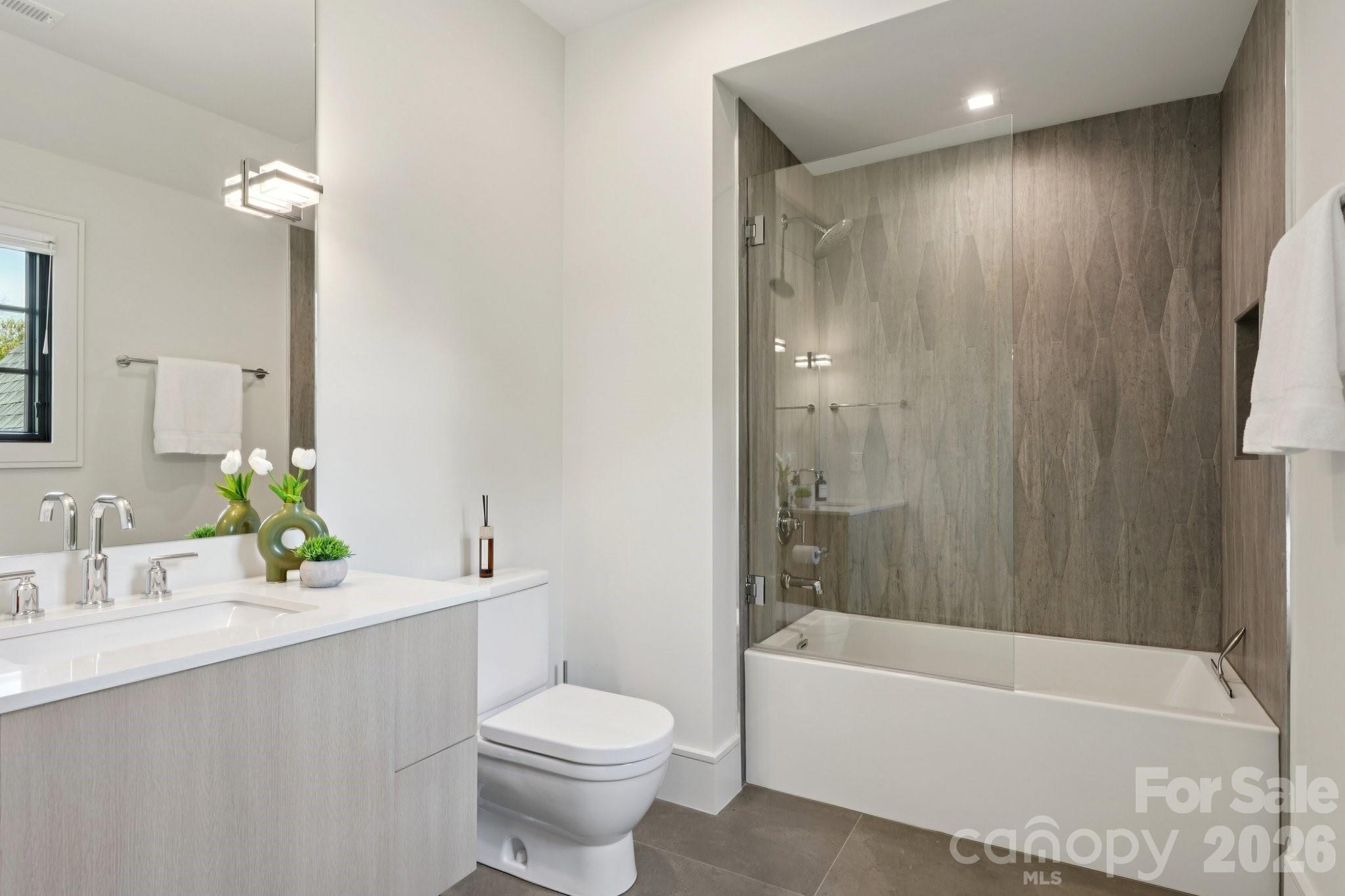 2103 Cortelyou Road Charlotte, NC 28211 - Photo 33 of 45 a bathroom with a bathtub shower sink vanity mirror and toilet