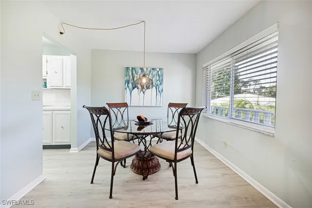 a view of a dining room with furniture window and outside view