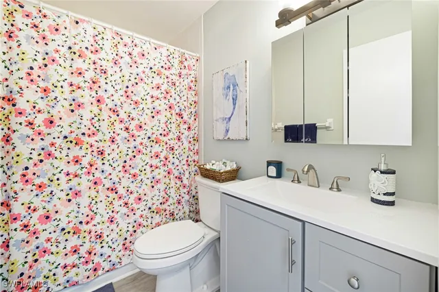 a bathroom with a sink toilet and a mirror