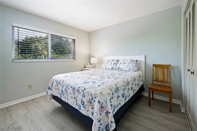 a large bed sitting in a bedroom next to a window