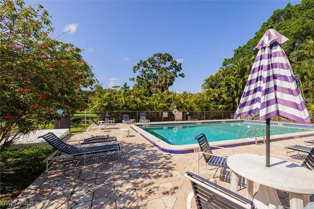 a swimming pool with outdoor seating yard and plants