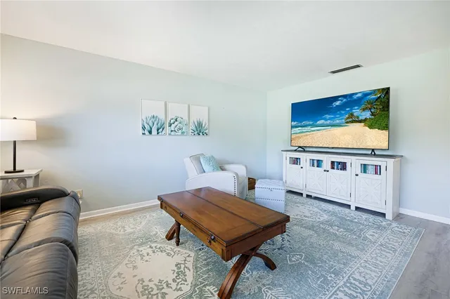 a living room with furniture and a rug