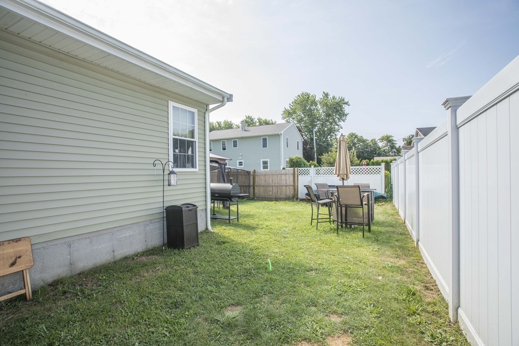 201 Riley Avenue Somerset, MA 02726 - Photo 4 of 22 a backyard of a house with table and chairs