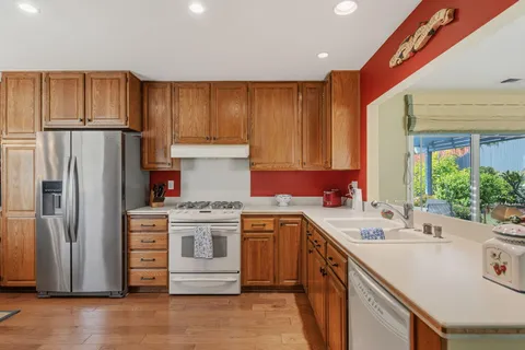 a kitchen with a sink stove and refrigerator