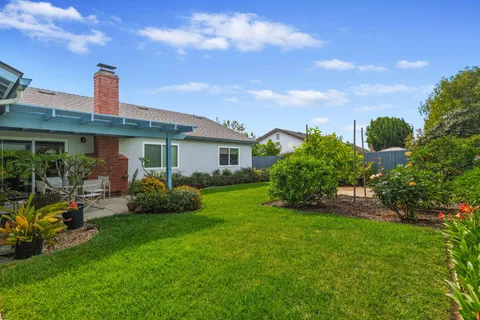 a front view of house with yard and green space