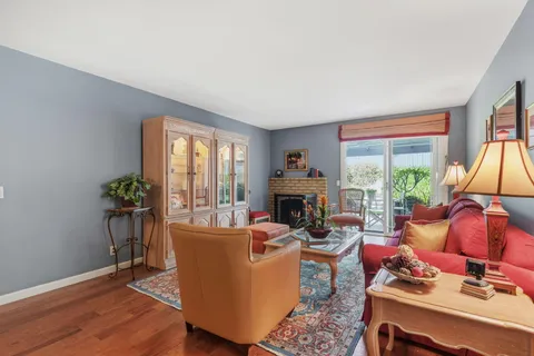 a living room with furniture a window and a potted plant