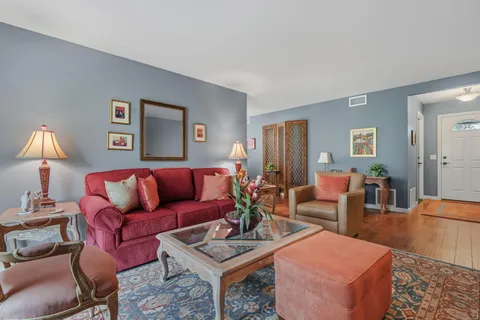 a living room with furniture a lamp and a table