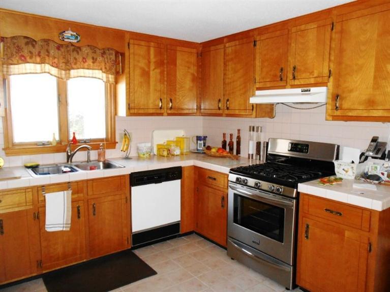 126 James Otis Road Centerville, MA 02632 - Photo 4 of 17 a kitchen with stainless steel appliances granite countertop a stove a sink and a microwave